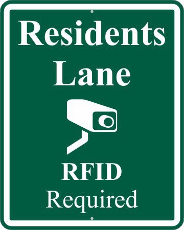 A sign that says rfid is required for residents to use the lane.